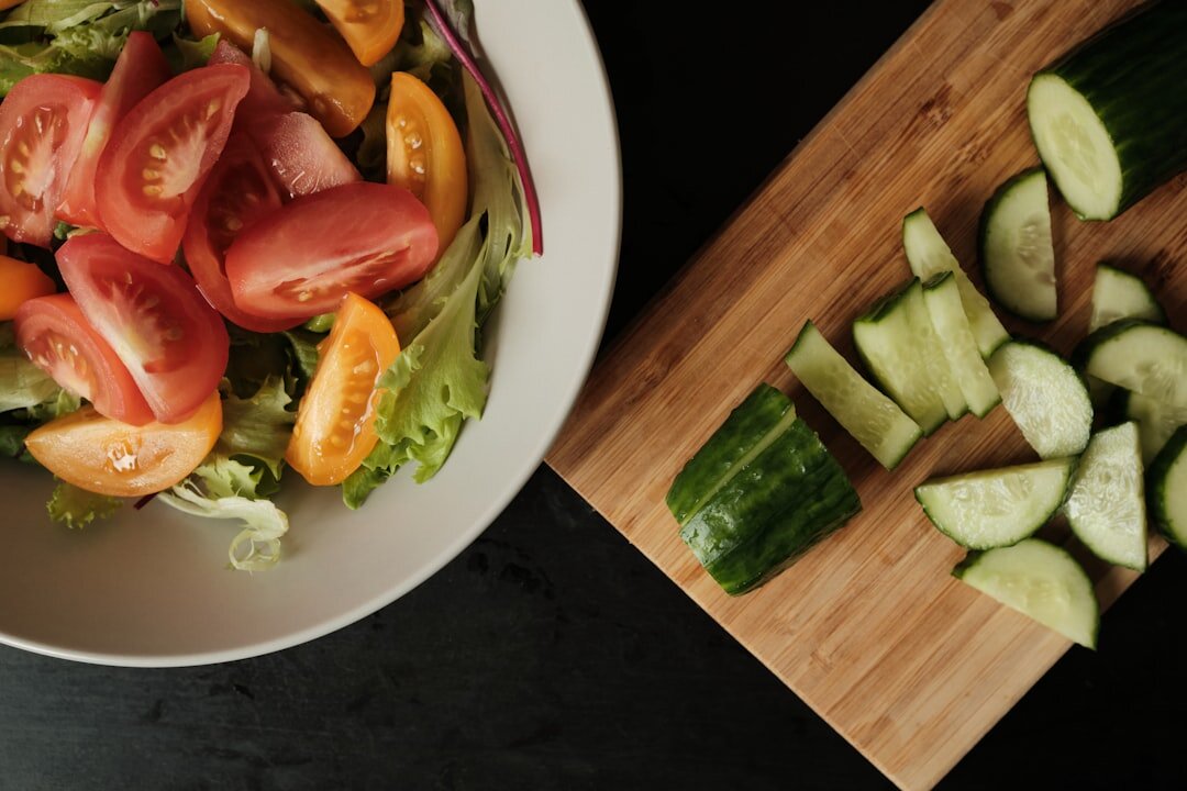 Fresh summer salad with garden tomatoes and cucumbers on a wooden table