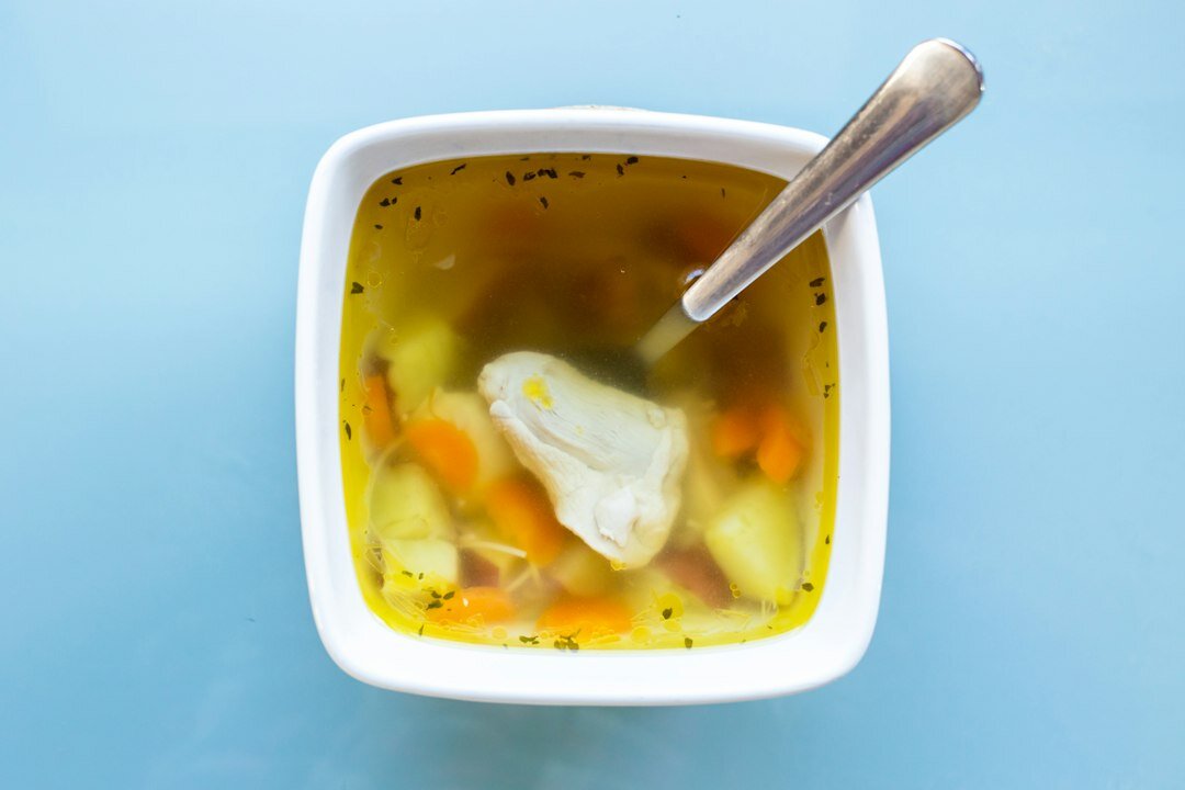 Bowl of Czech kulajda sour cream mushroom soup with a poached egg
